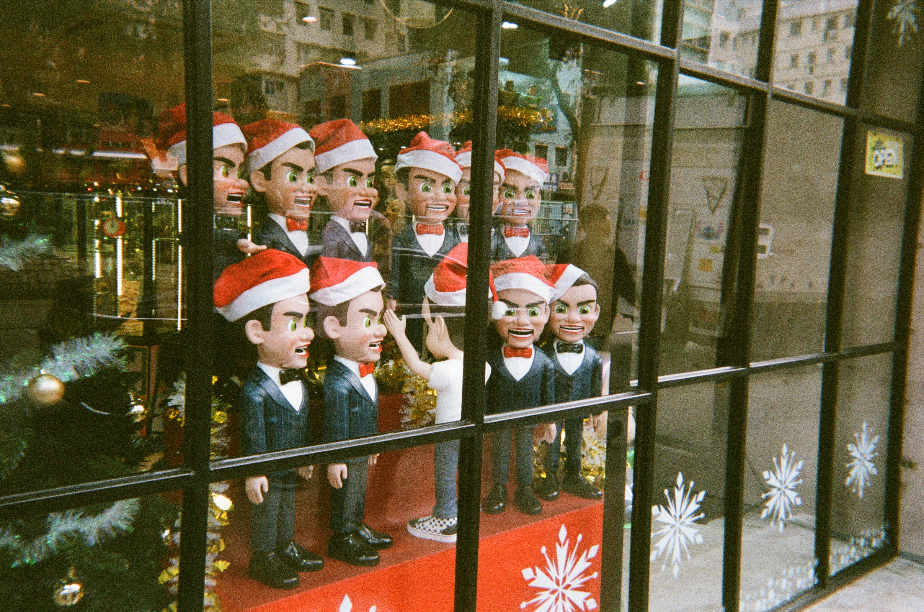 Christmasy choir figures lining up in a Shamshuipo shop, Hong Kong.